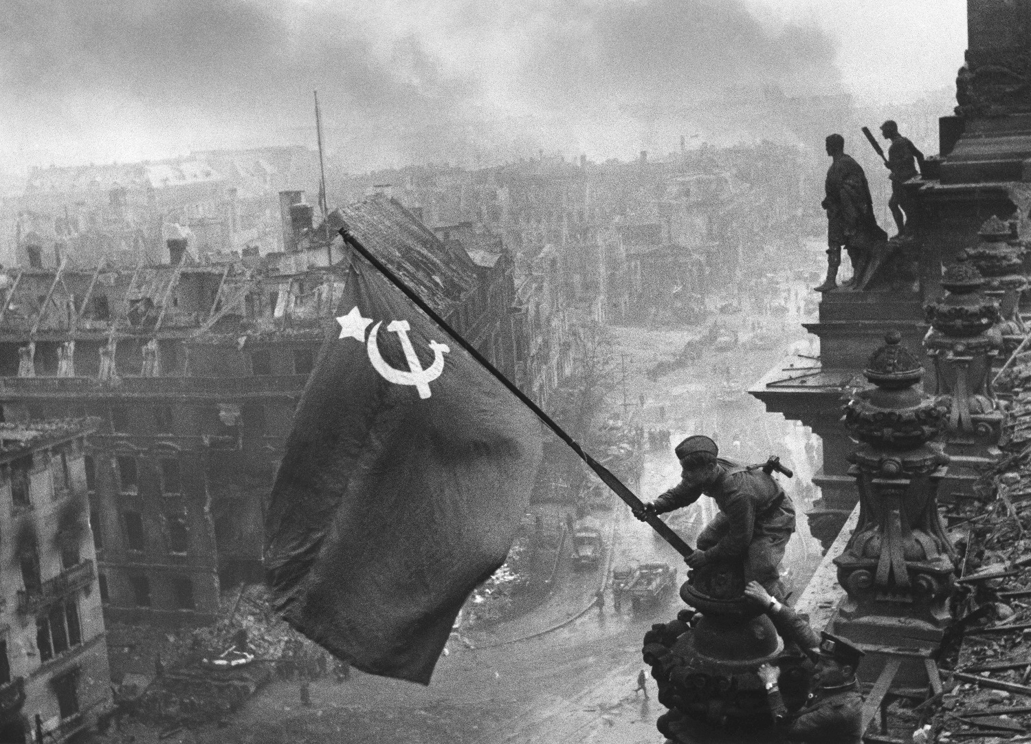 Reichstag - The original Raising a Flag Over the Reichstag photo - note the soldier supporting the one attaching the flag, with two watches, one on each wrist